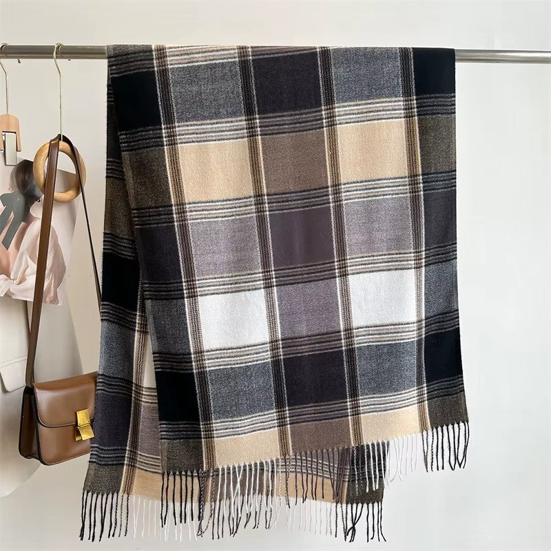Écharpe plaid écossais noire et beige suspendue à un portant